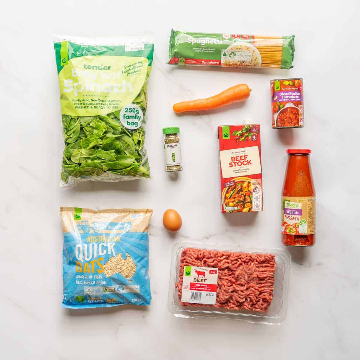 The ingredients to make baked spaghetti and meatballs laid out on a bench top.