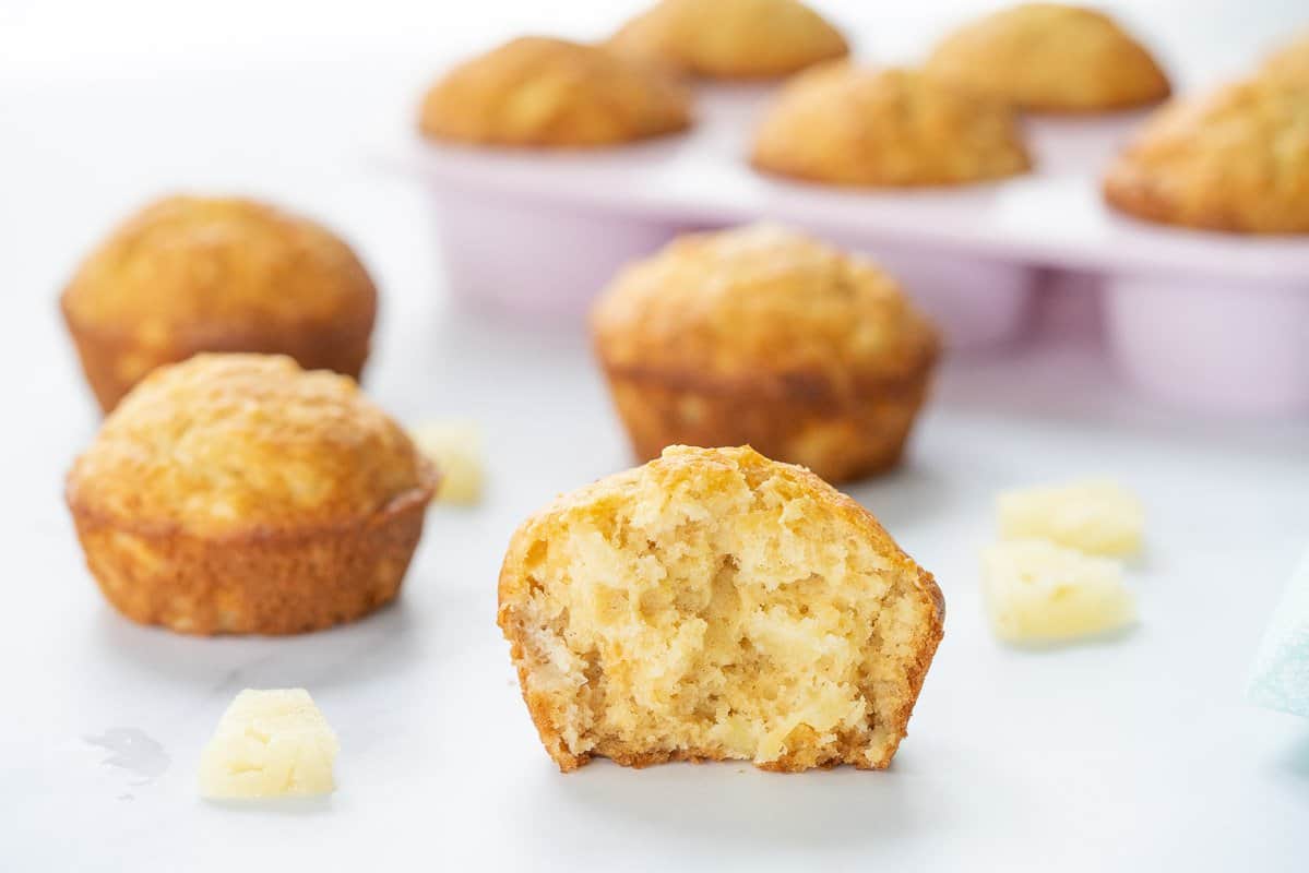 A close up of pineapple muffin broken in half showing the soft texture.