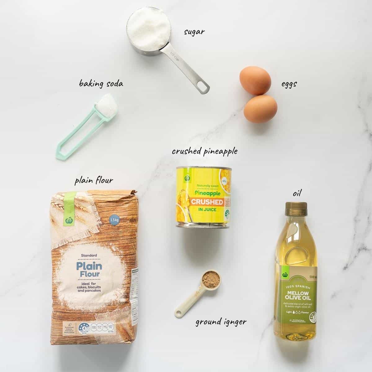 The ingredients to make pineapple muffins laid out on a bench top with text overlay.