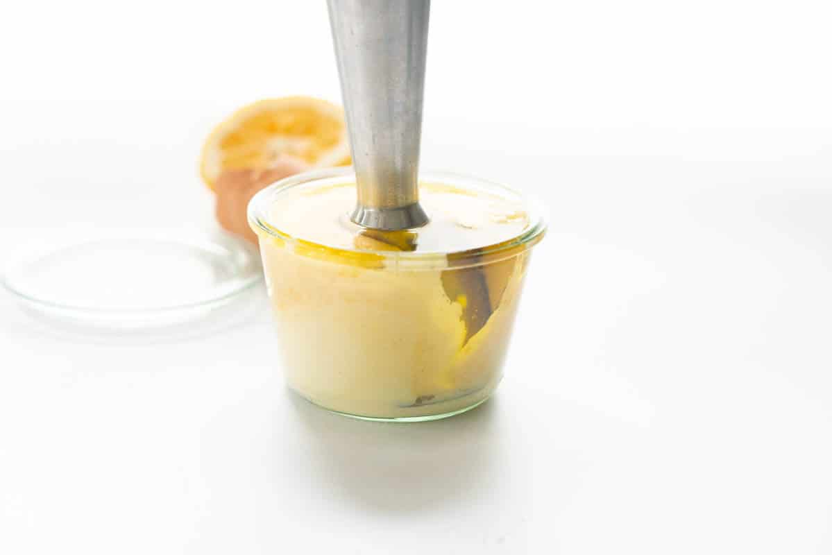 Mayonnaise forming in a glass jar.