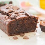 Close up of the inside of a chocolate loaf, chunks of ripe banana visible.