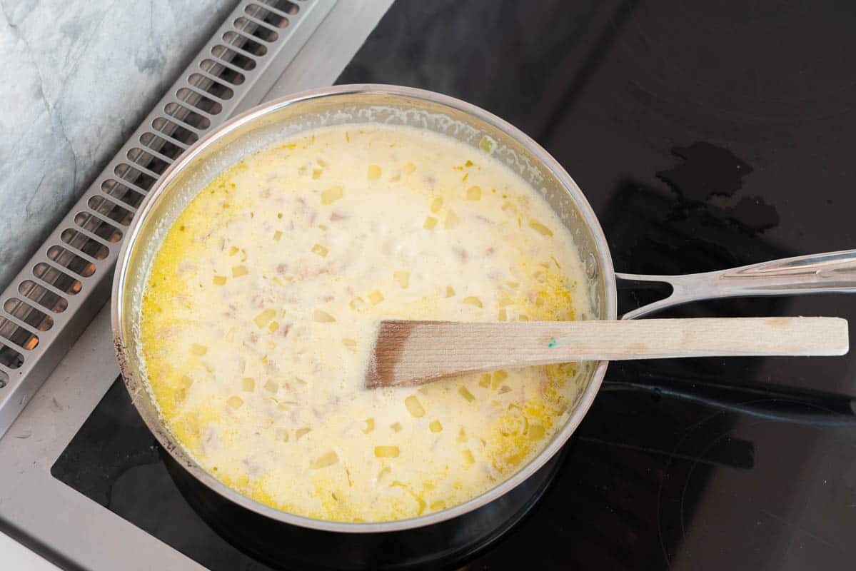 Creamy tuna sauce simmering in a stainless steel fry pan..