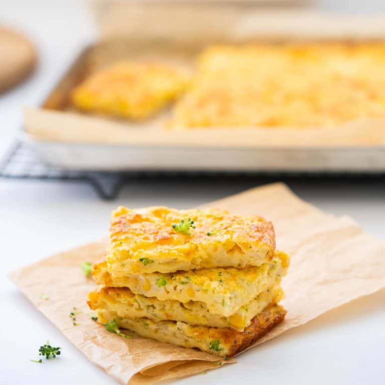 Four pieces of vegetable slice staked in a tower on top of crumpled brown parchment paper.