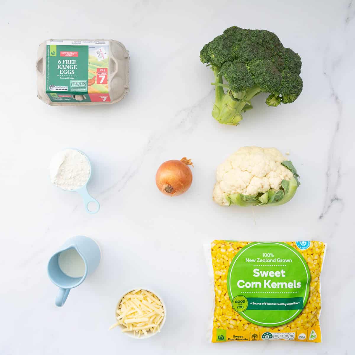 The ingredients to make vegetable slice laid out on a marble bench top.