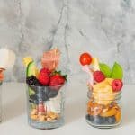 Two jarcuteires setting in front of a grey marble splash back.