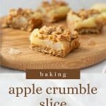 A piece of apple oat slice sitting on a round wooden board, with text overlay.