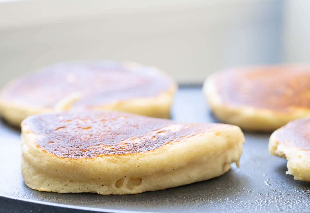 Thick pancake cooking on a no stick pancake pan.