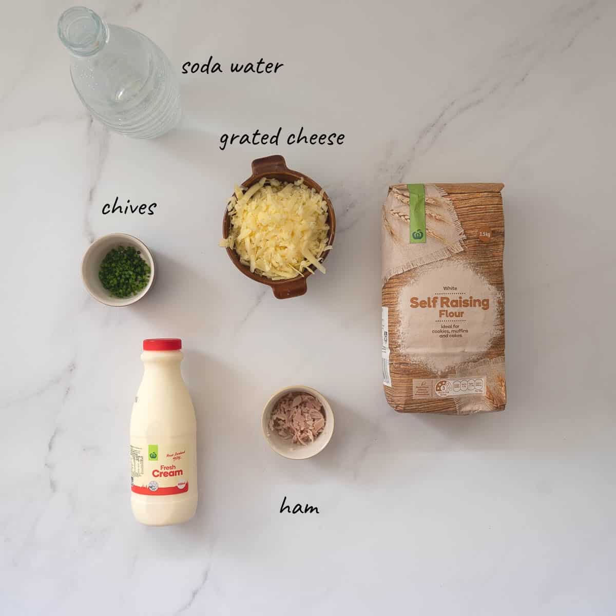 The ingredients to make savoury scones laid out on a bench with text overlay.