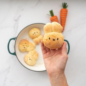 A gluten free dinner roll baked into the shape of a bunny face with 2 ears.