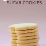 A tower of flower shaped cookies on a pink background with text overlay