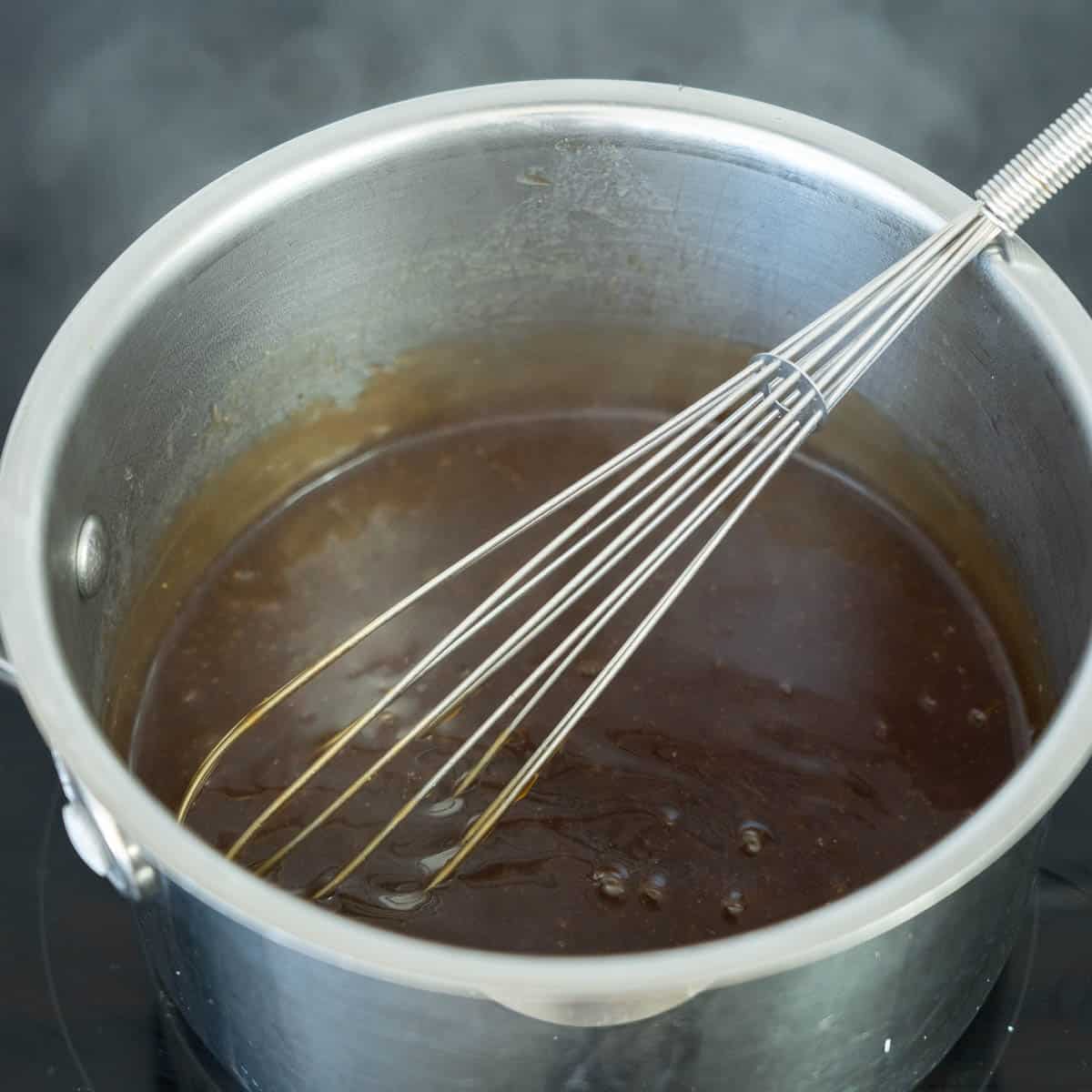 Thickened teriyaki sauce in a small sauce pan,