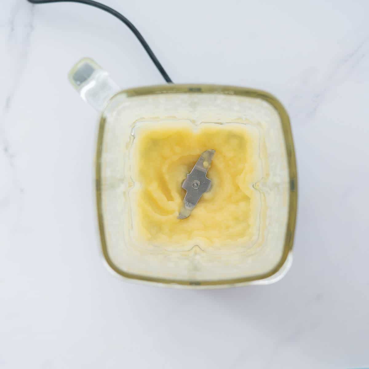 Pureed apples in a glass blender.