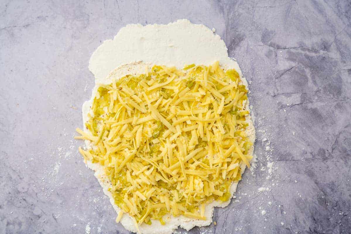 Grated cheese and cooked leeks on top of our cream and mustard spread over a rectangle pizza base.