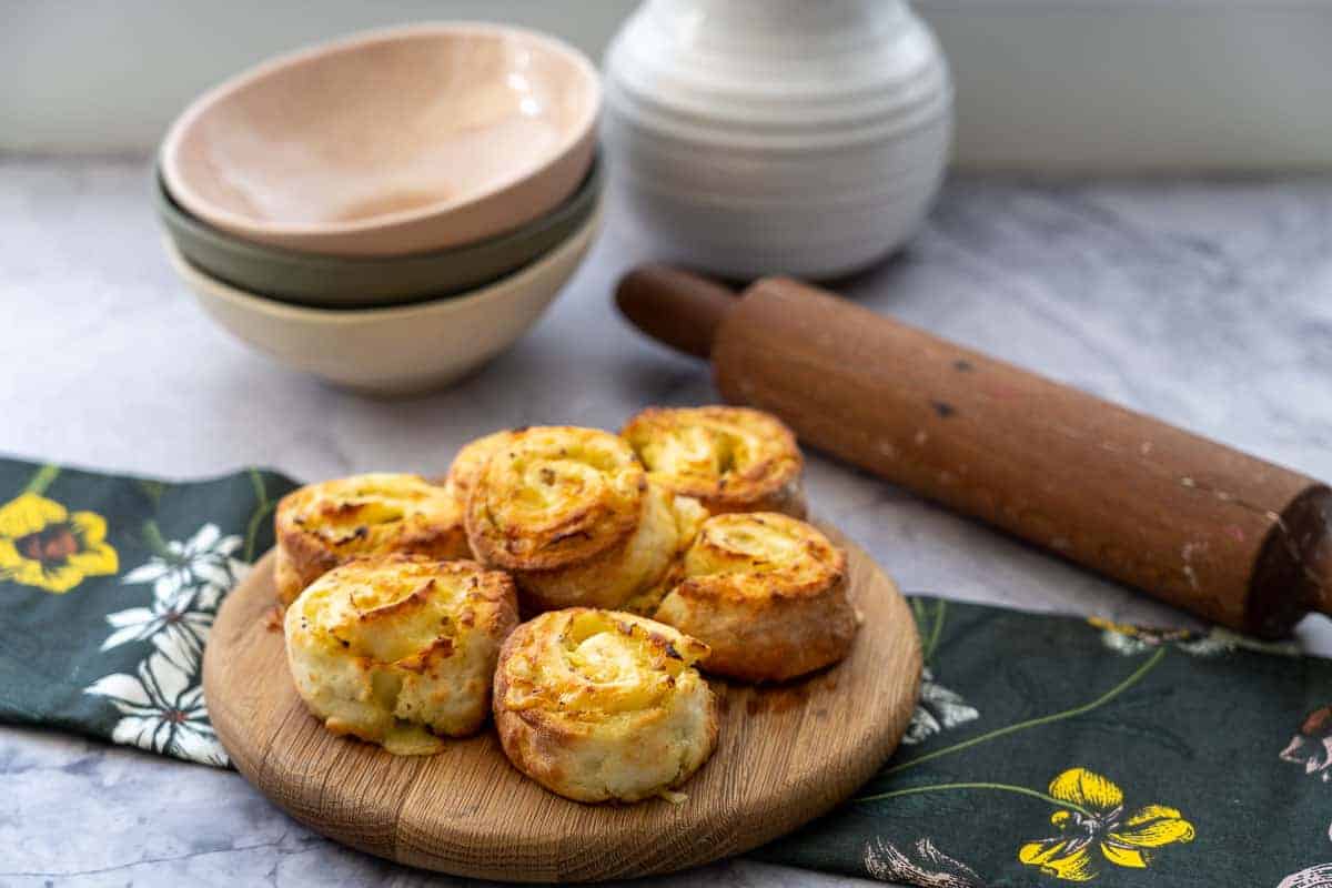 Scrolls stacked on a round wooden chopping board.