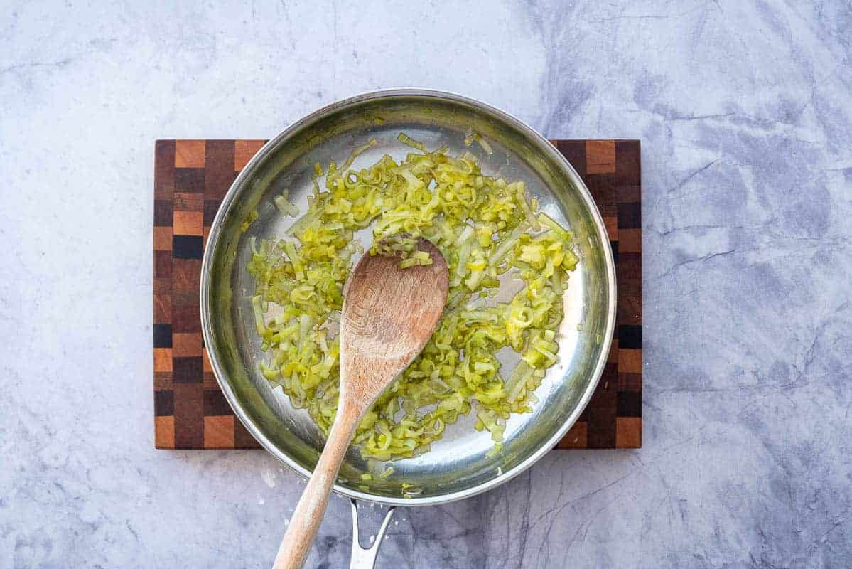 Cooked sliced leek in a stainless steel pan