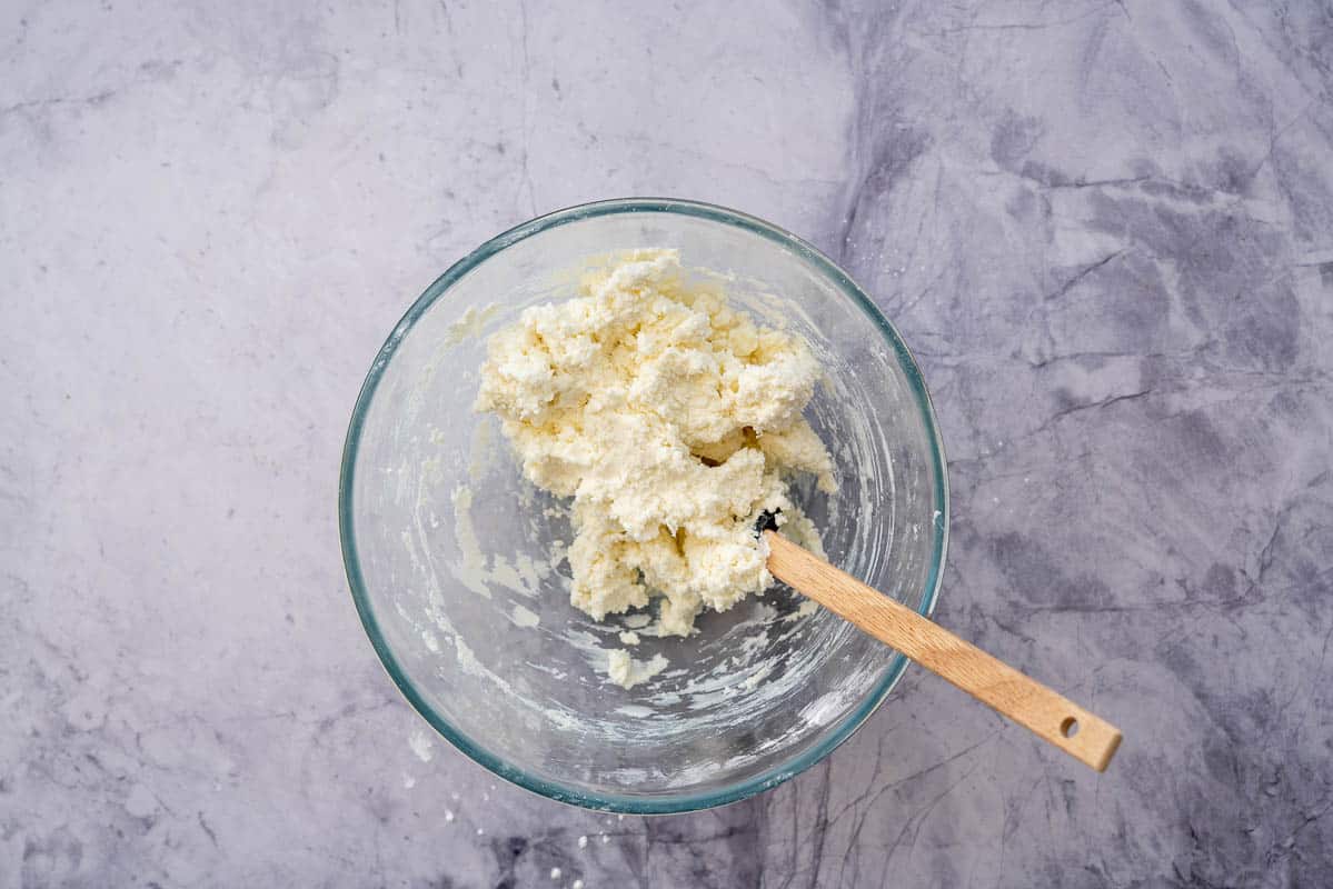 Sticky clump of dough in a glass mixing bowl.