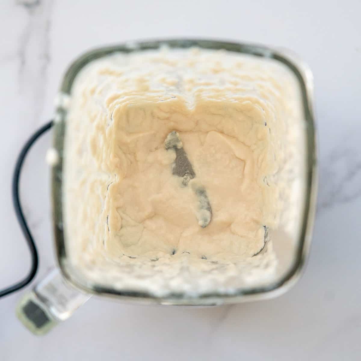 Purreed chicken in a glass blender jug.