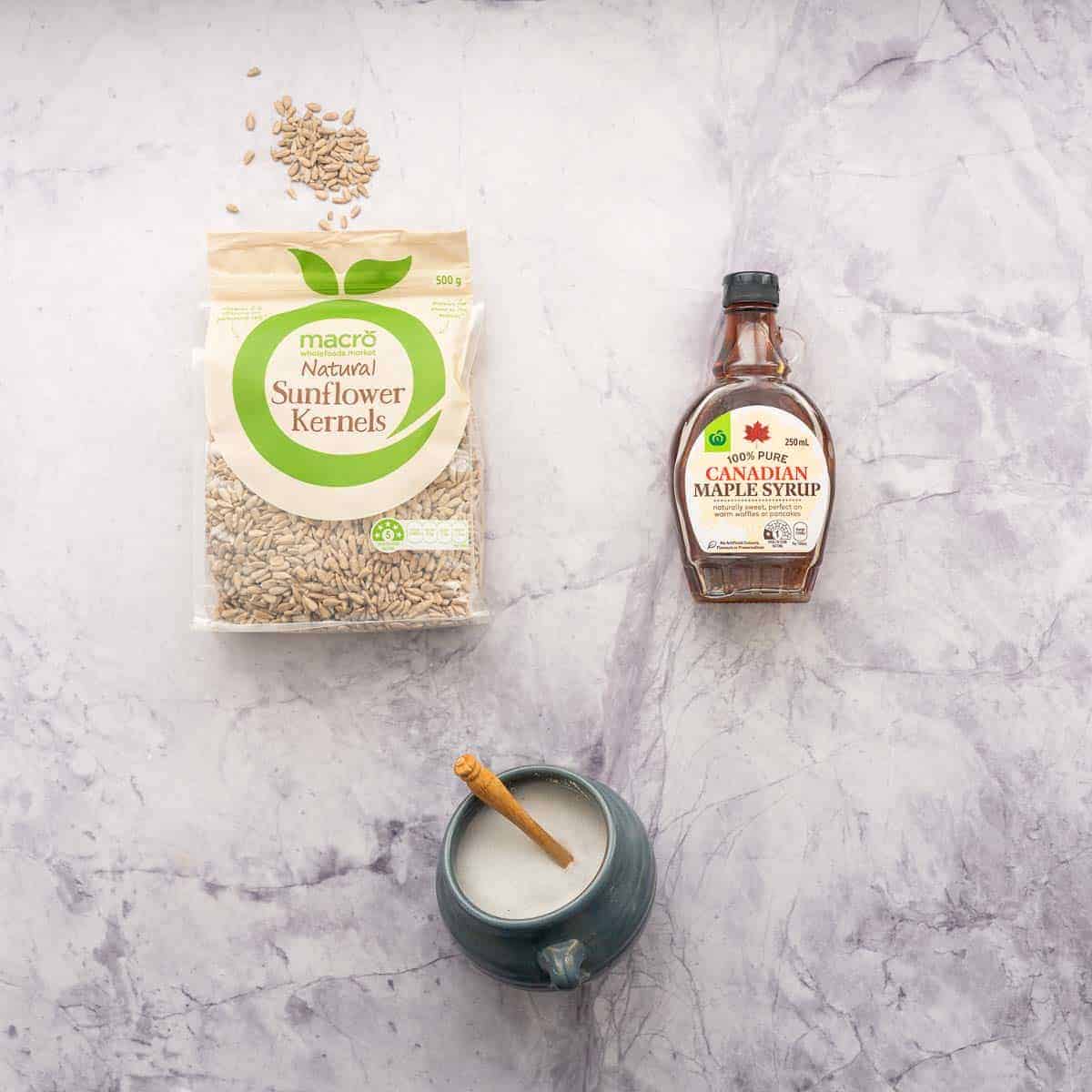 Sunflower seeds and maple syrup packets with a salt pig filled with salt.