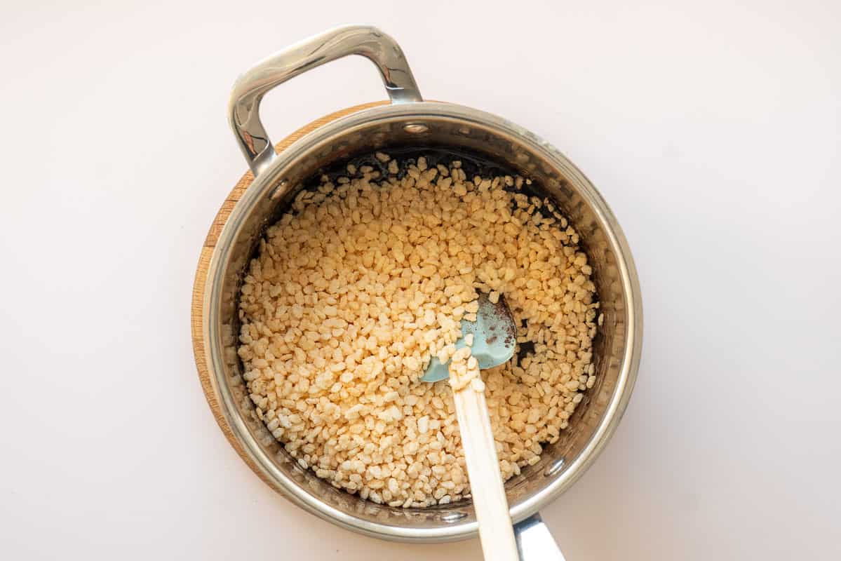 Puffed rice cereal in a saucepan with a chocolate batter.
