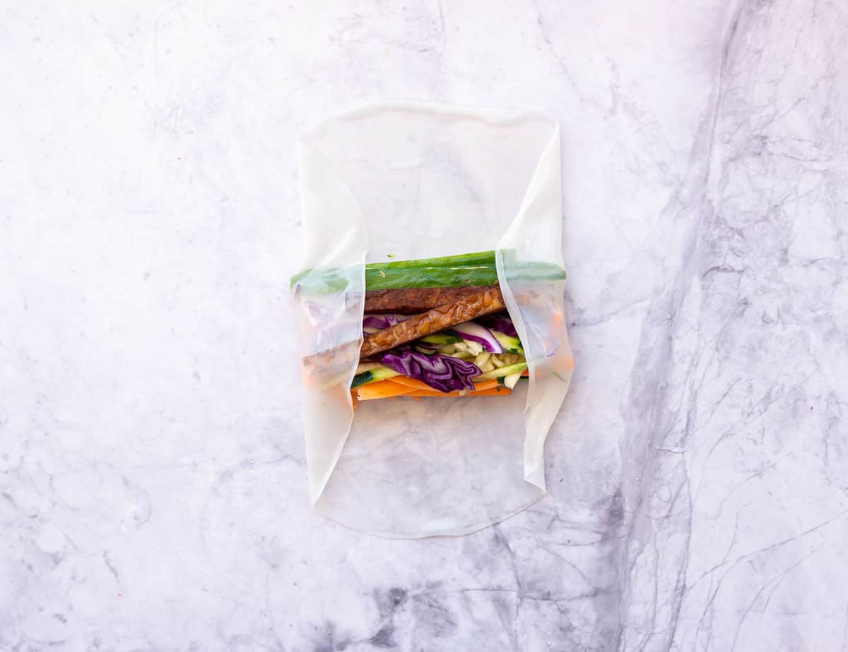 Two sides of rice paper folded in on the vegetables.