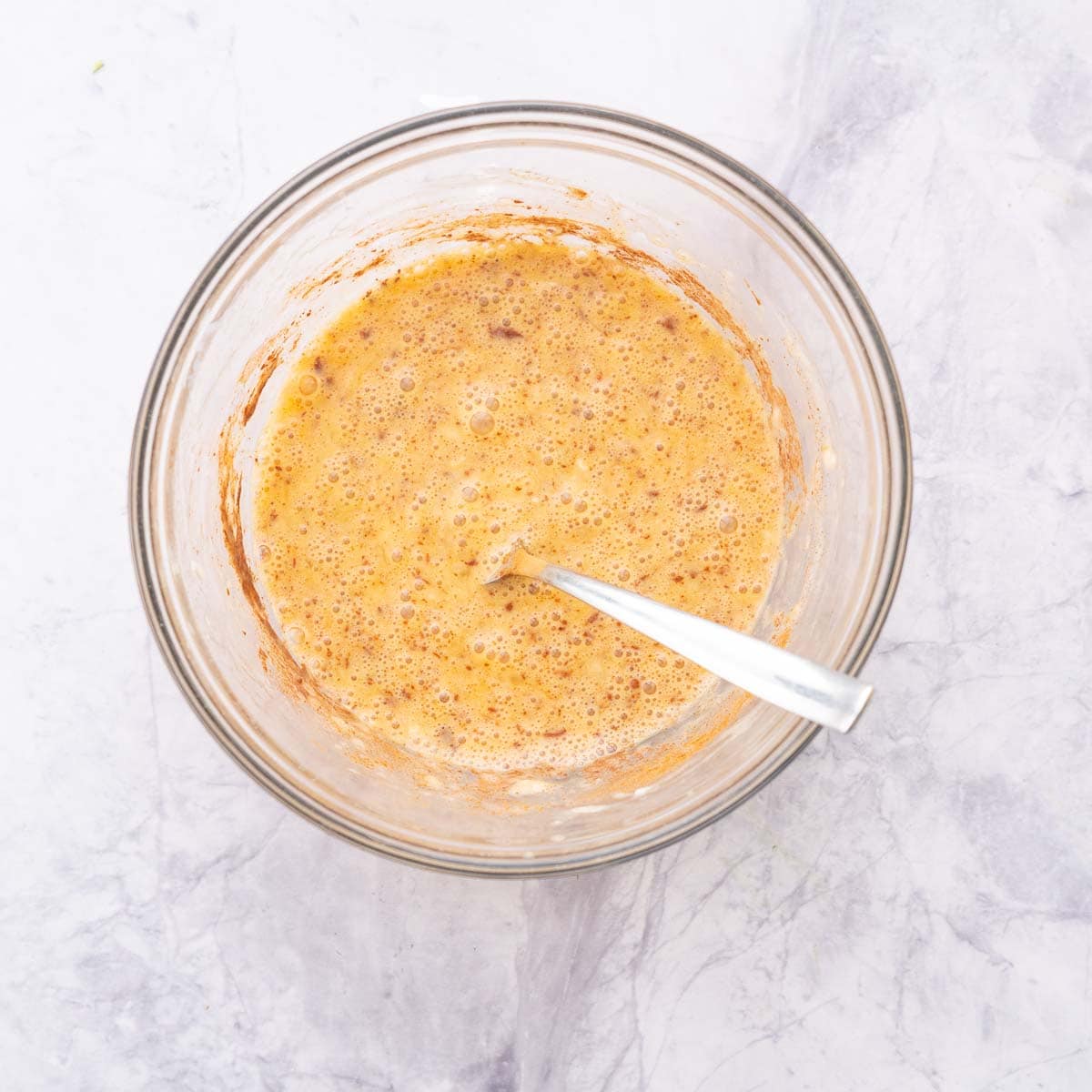 banana egg pancake batter in a glass mixing bowl