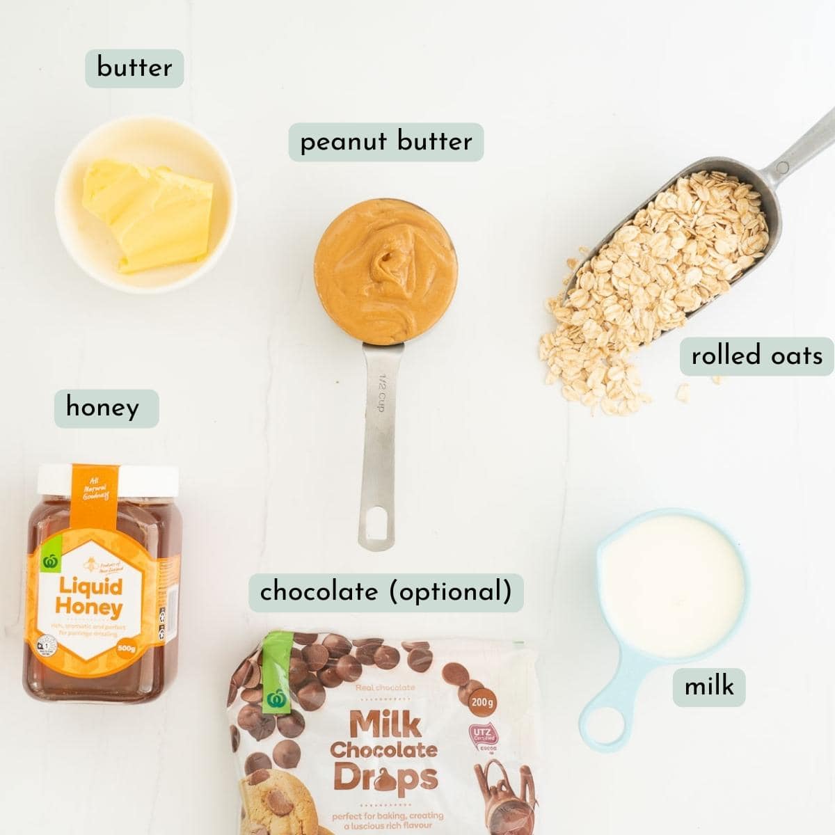 The ingredients to make peanut butter oatmeal bars laid out on a bench top with text overlay.