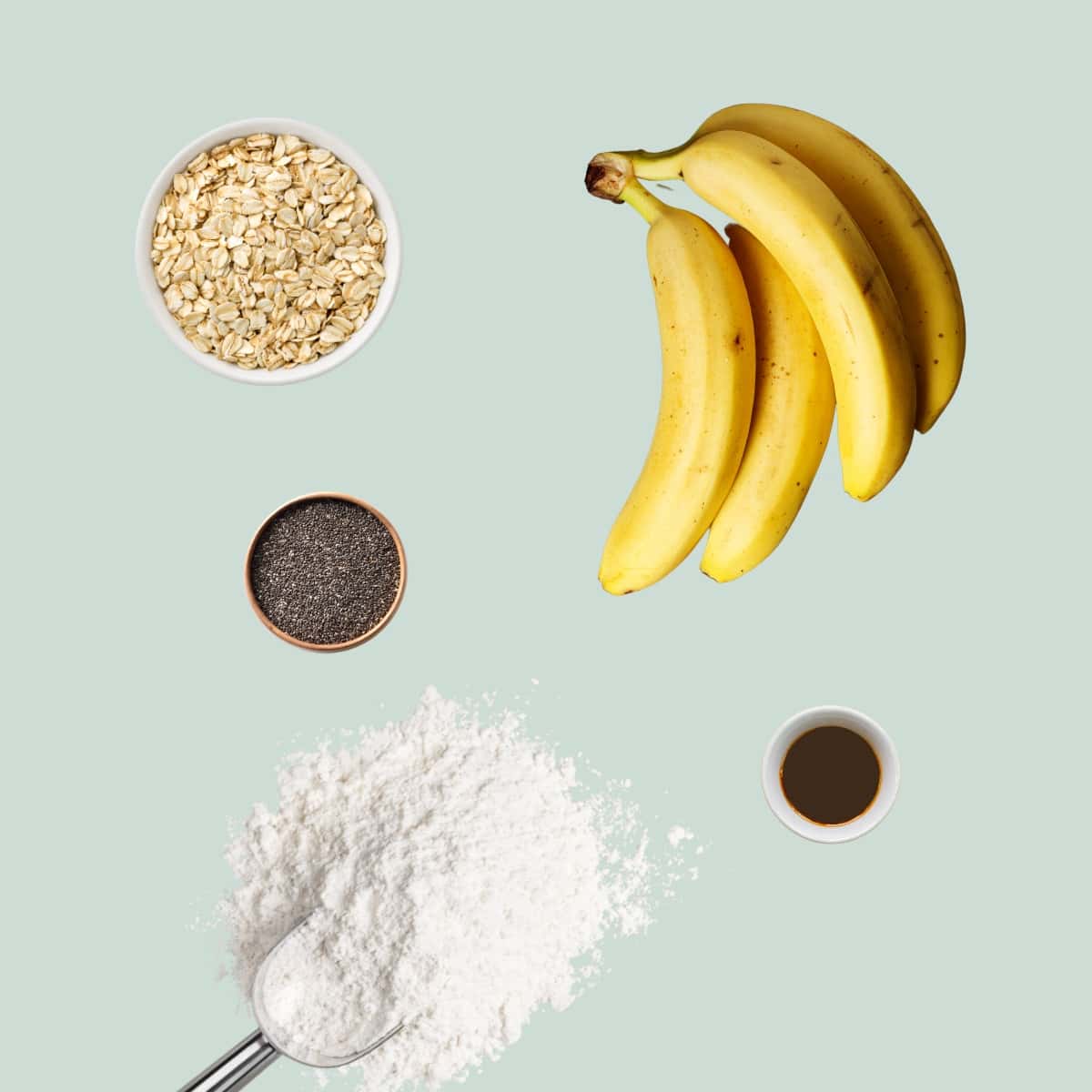 The ingredients to make baby cookies laid out on a mint green background.