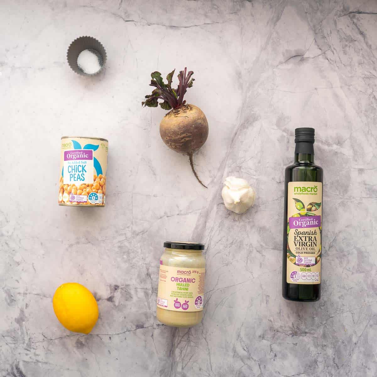 The ingredients to make roasted beet hummus laid out on a bench top.