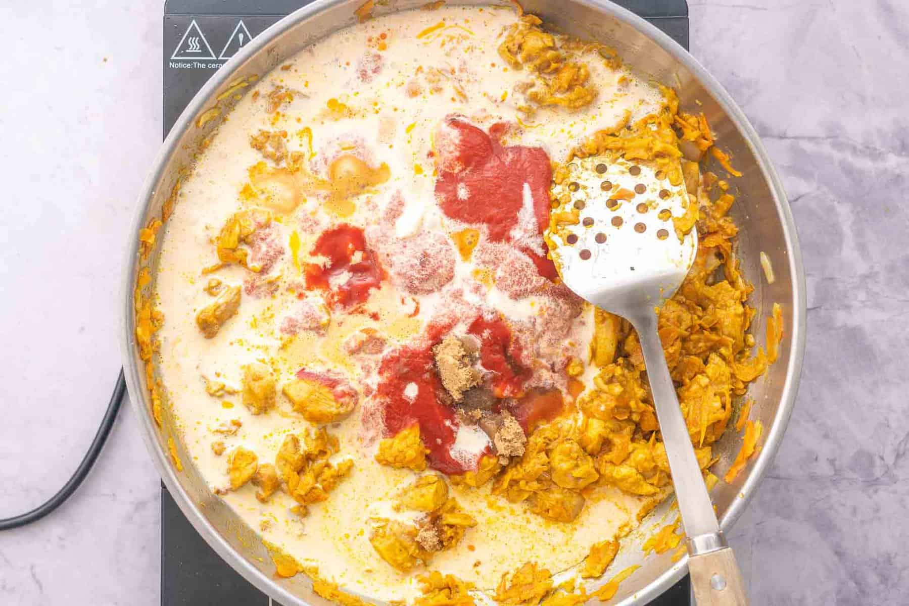 Remaining ingredients added to the frying pan simmering on the element 