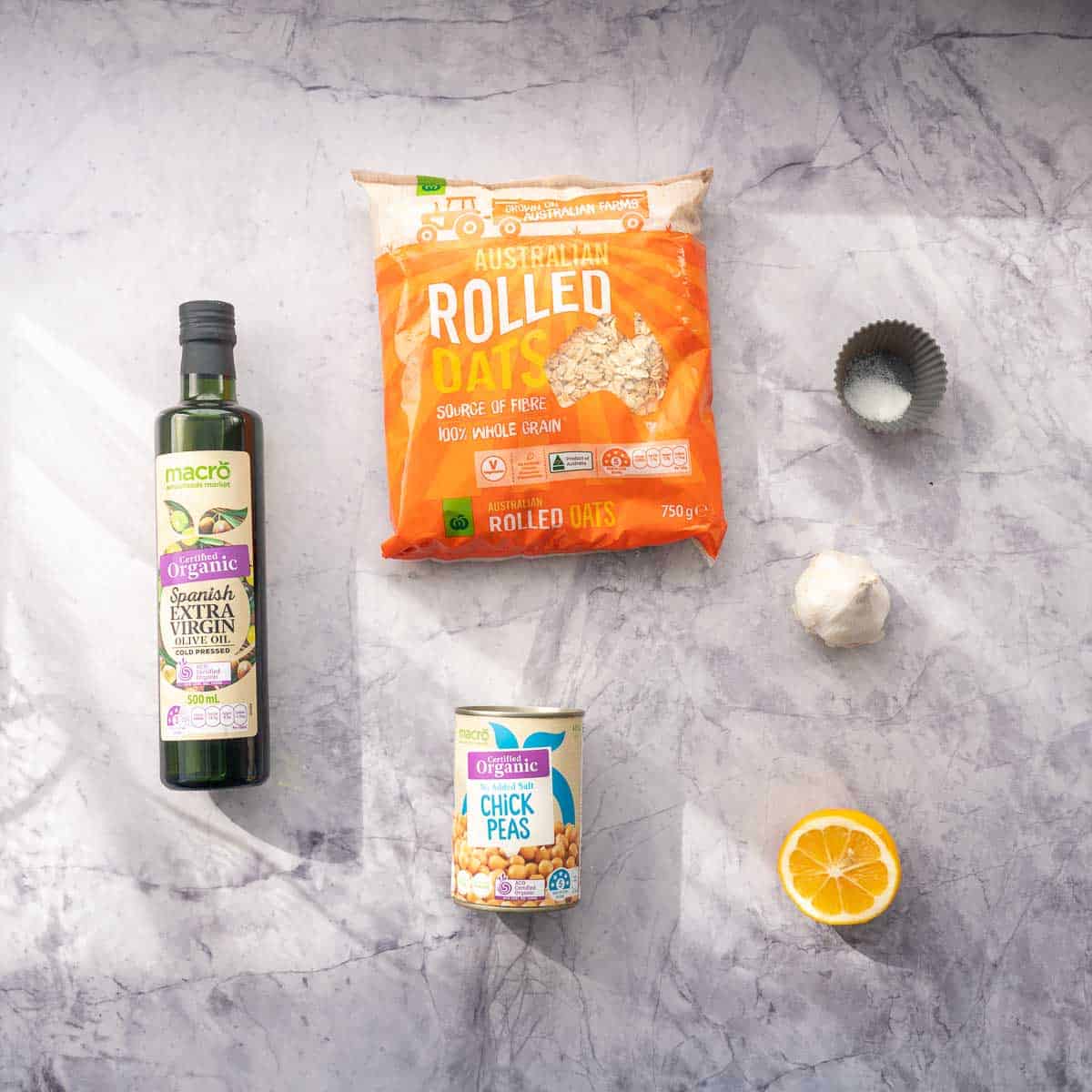 The ingredients to make chickpea crackers laid out on a marble bench top.