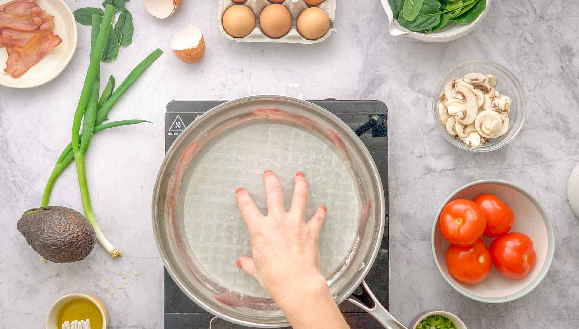 Rice paper being placed into oiled pan.