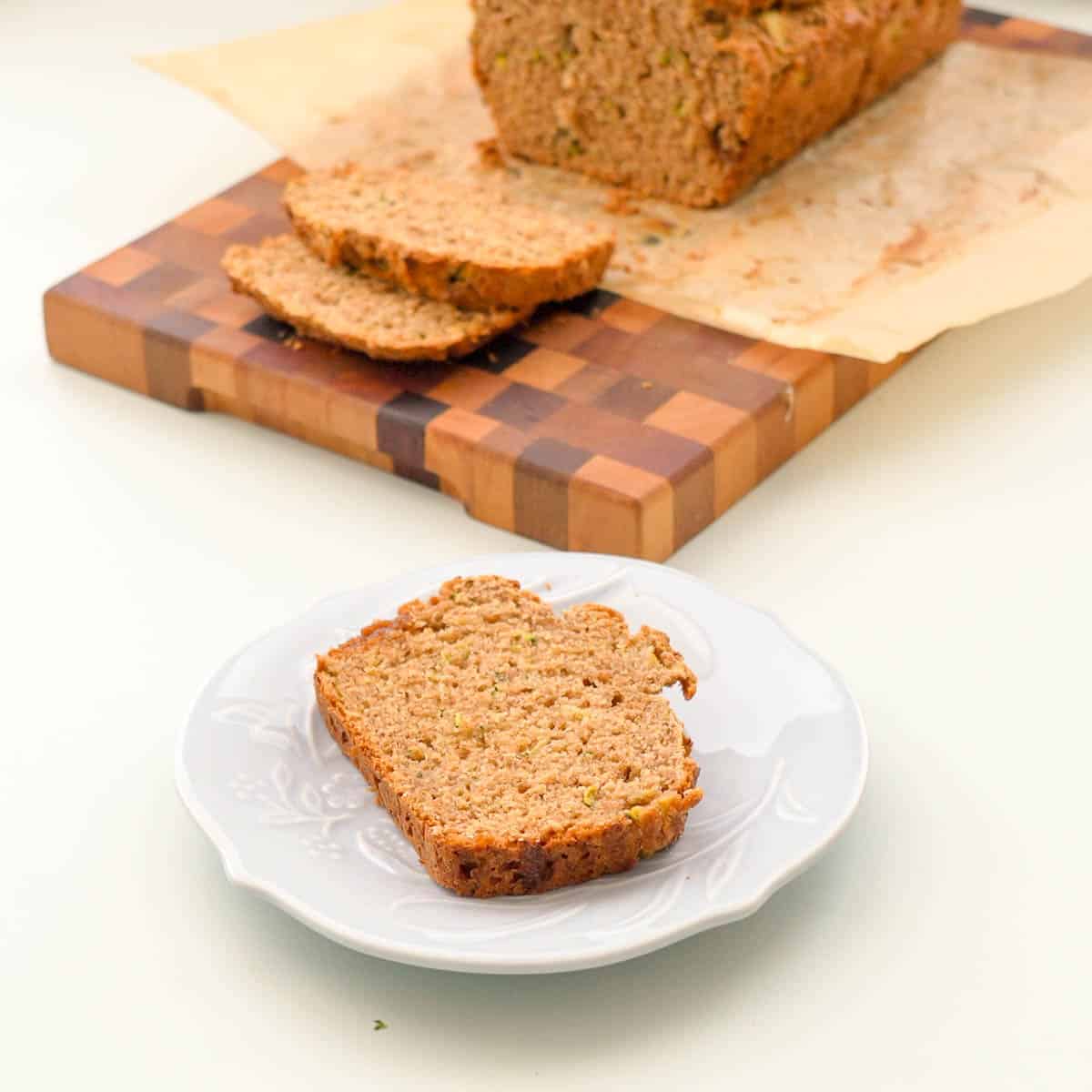 A slice of banana bread on a patterned side plate.