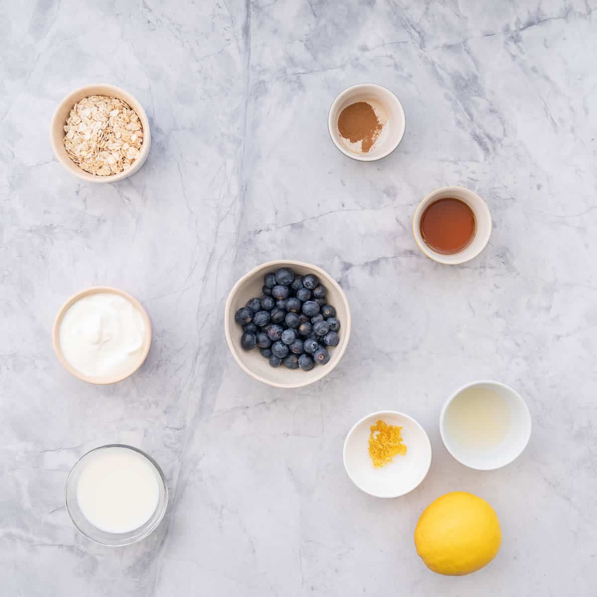 All the ingredients to make the Blueberry overnight oats laid out on the bench.