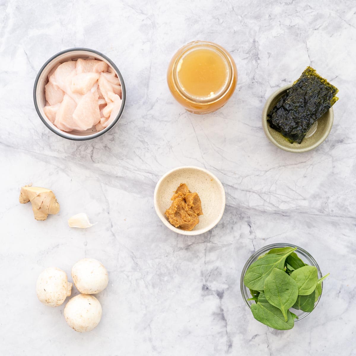 All the ingredients to make the Chicken Miso Soup laid out on the bench in ramekins