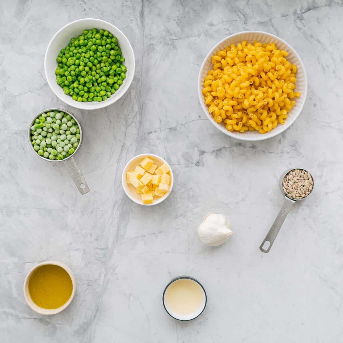 All the ingredients to make the Pea Pasta laid out on the bench in small serving dishes