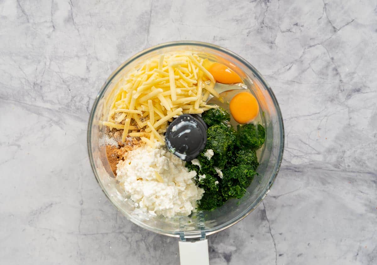 Spinach, eggs, grated cheese and cottage cheese in a food processor.