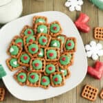 Square pretzels with green icing and in the middle.