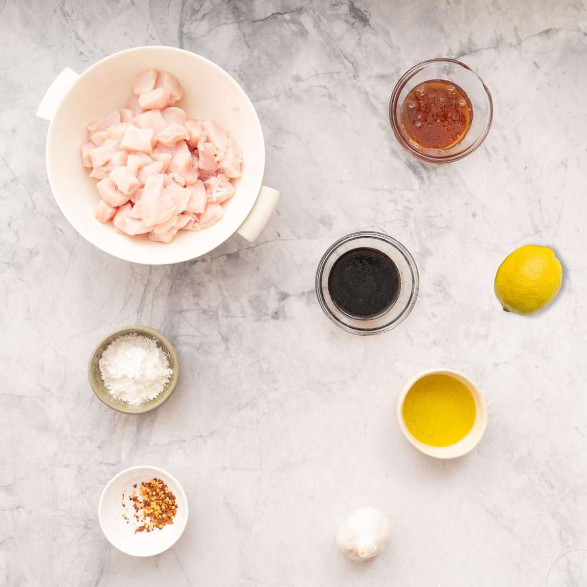 All the ingredients to make the honey garlic chicken laid out on the bench