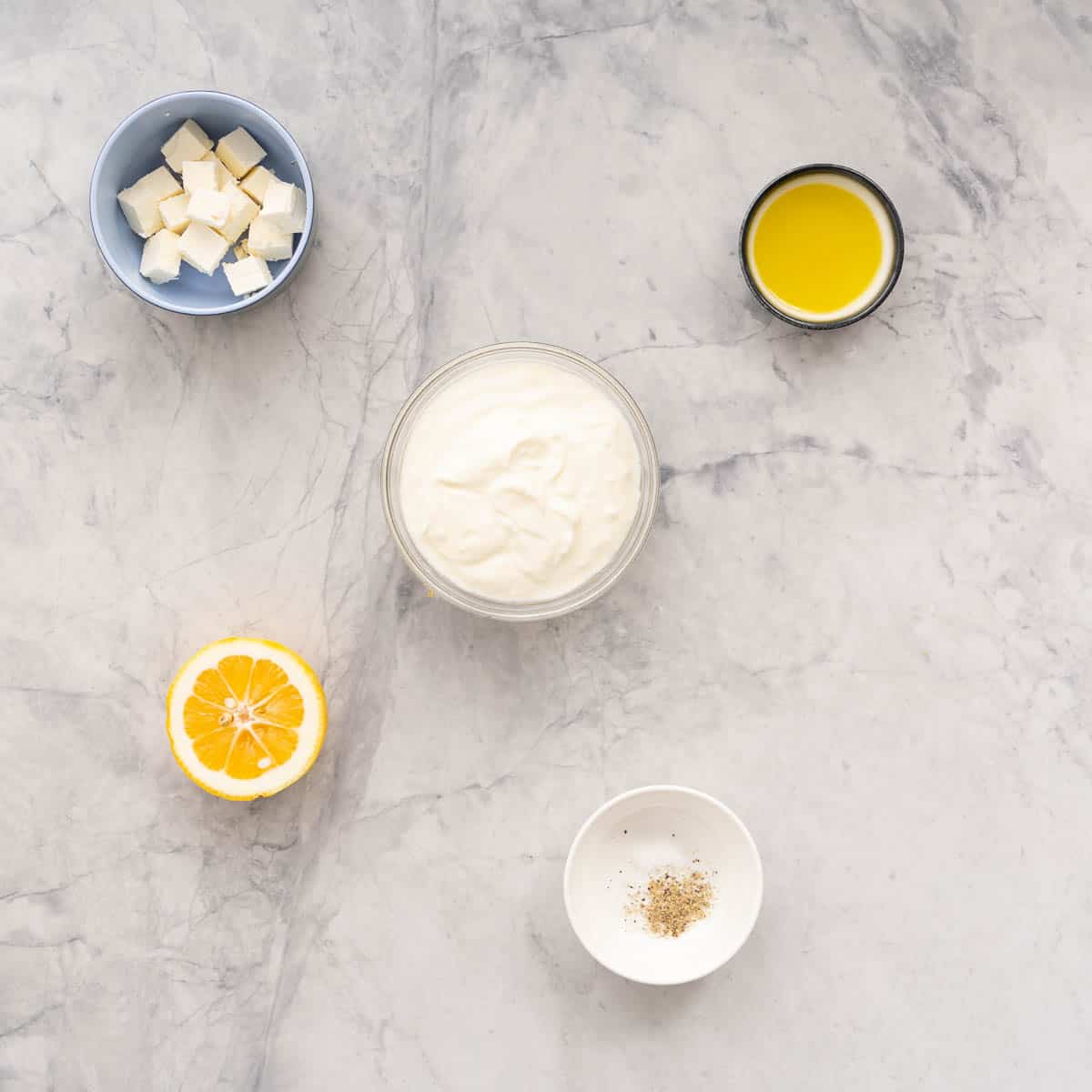 All the ingredients to make the Lemon Feta Dip laid out on the bench in small serving dishes