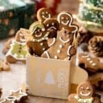A small christmas box with fivegingerbread men inside, decorated with different facial expressions.