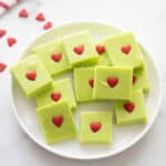 Plate with square green pieces of fudge with small red hearts in the middle.