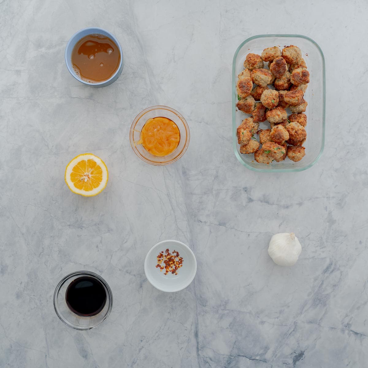 Ingredients for Honey garlic meatballs laid out on bench top.