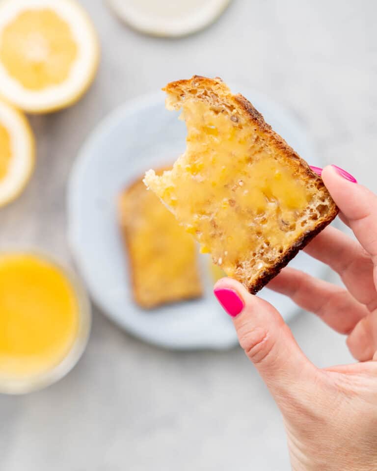 a piece of toast spread with lemon curd.
