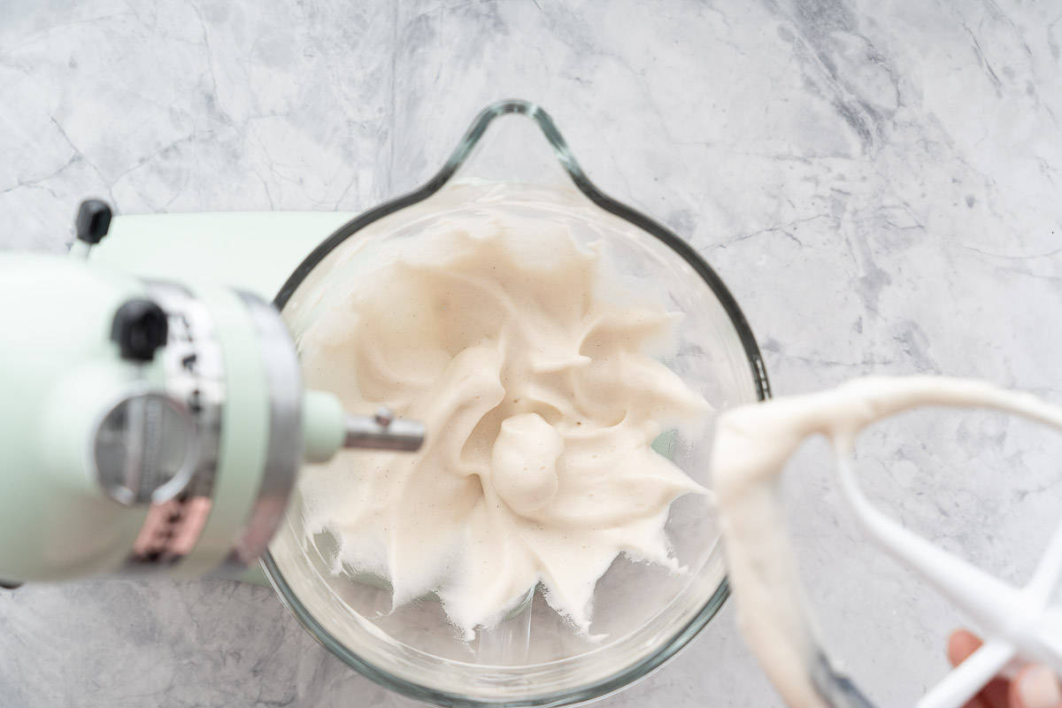 Aquafaba whipped to soft peak stage in a stand mixer.