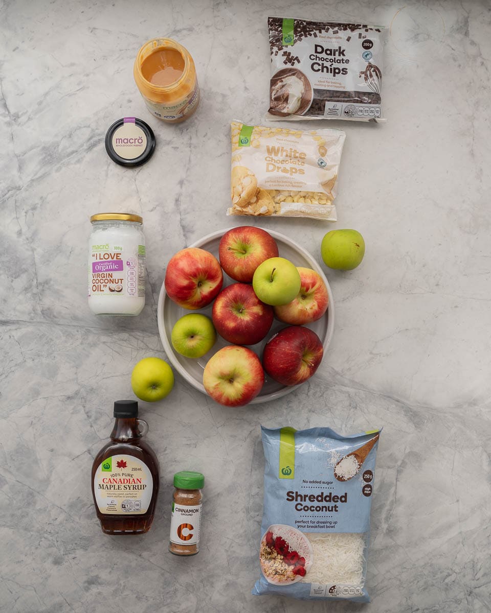 The ingredients to make apple nachos with caramel sauce laid out on a bench top.