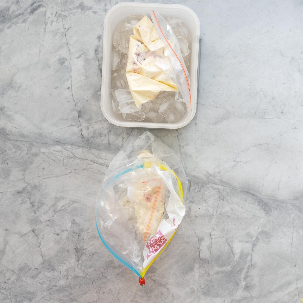 A small zip lock bag of ice cream ingredients inside a big zip lock bag of ice and salt.