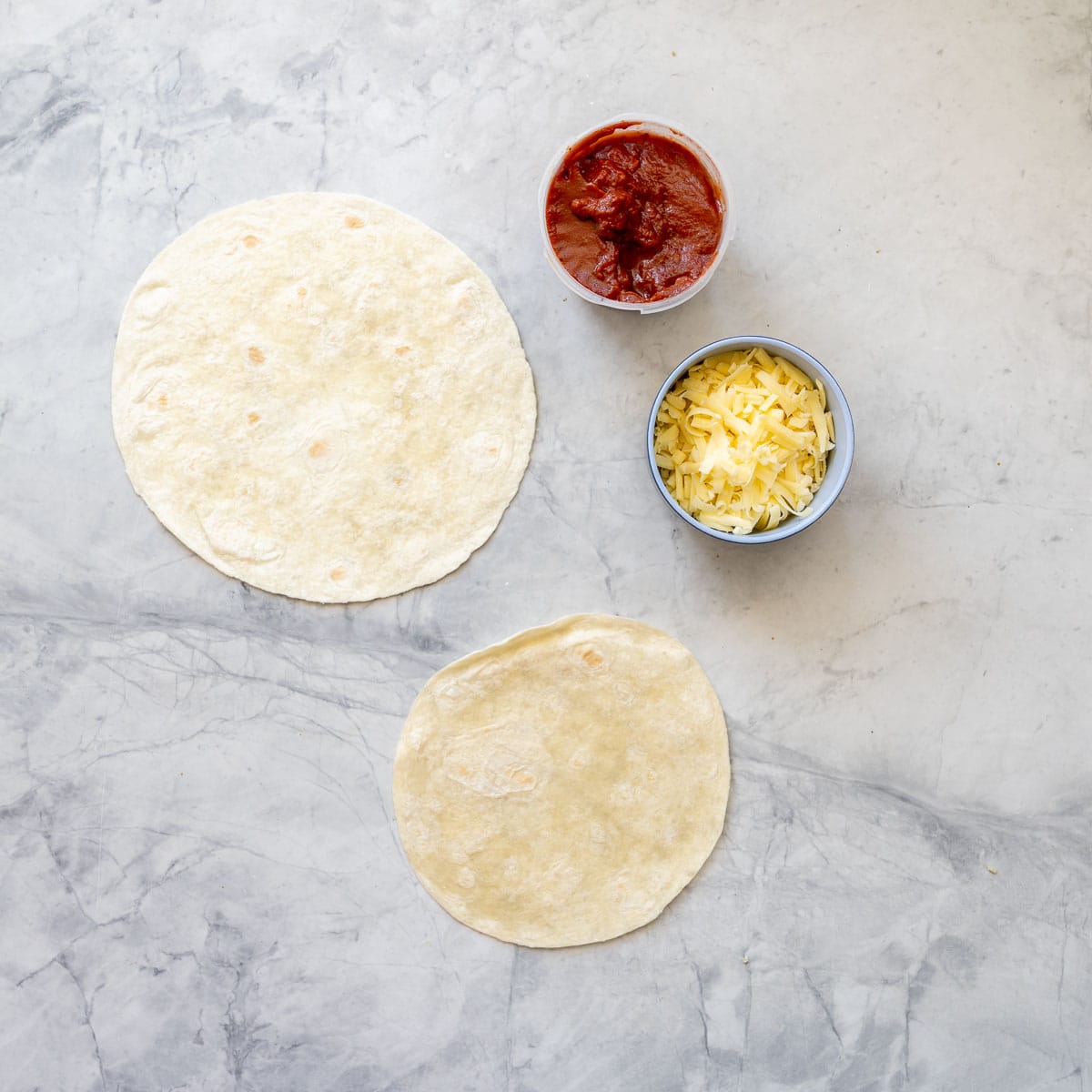 All the ingredients laid out on the bench to make the tortilla pizzas