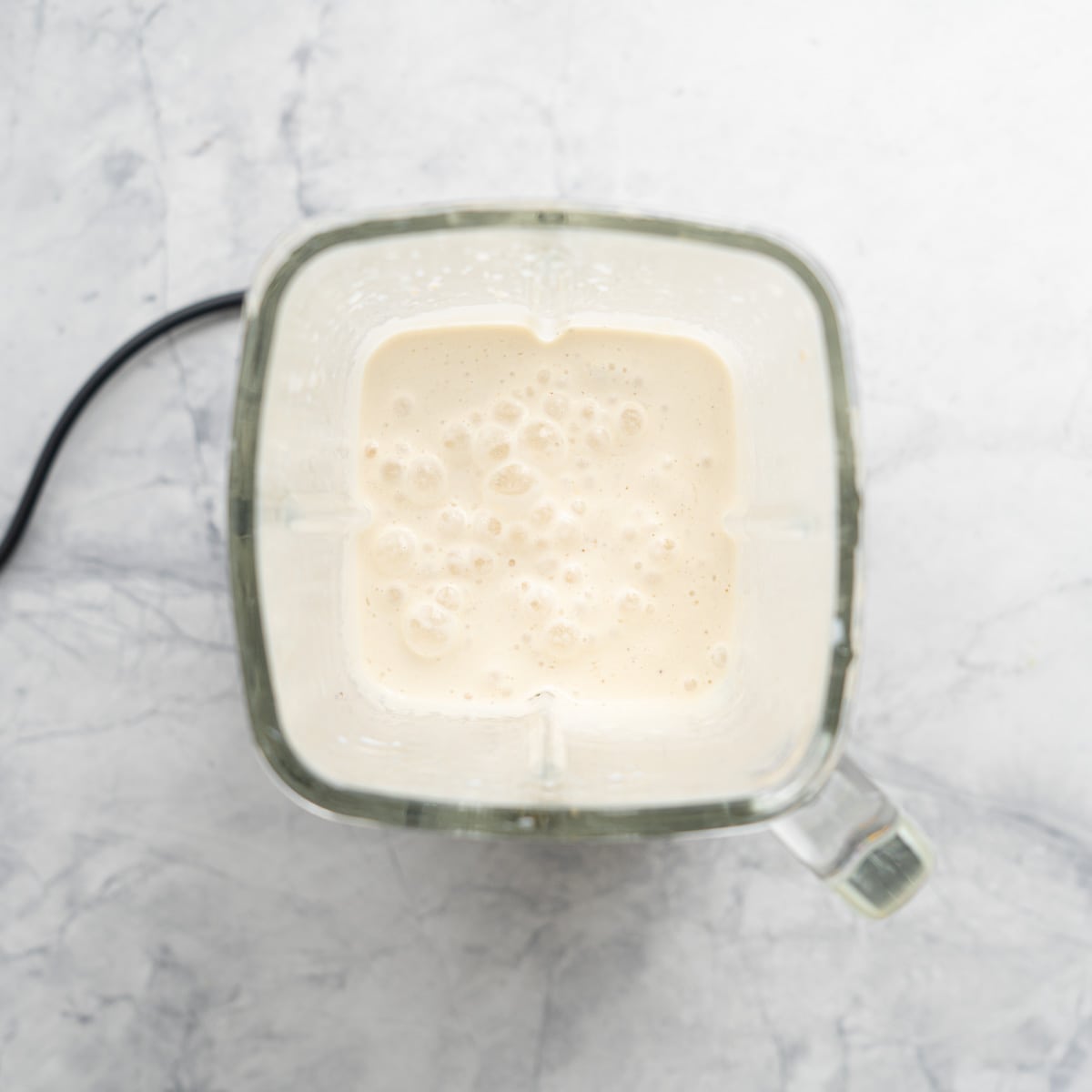 All the ingredients in the blender on the bench, whizzed together