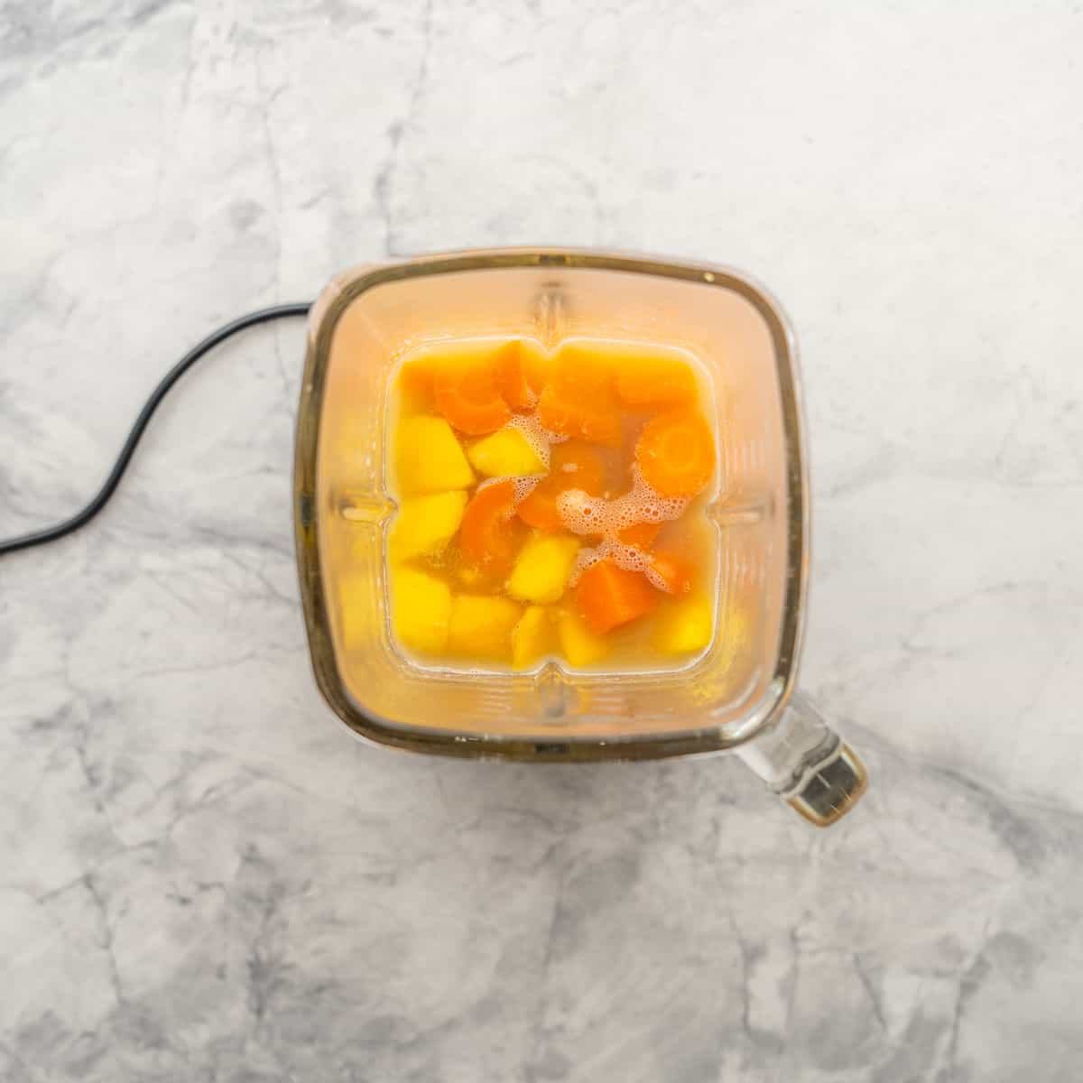 Cooked carrots, lentils and stock added to a blender, along with the mango. 