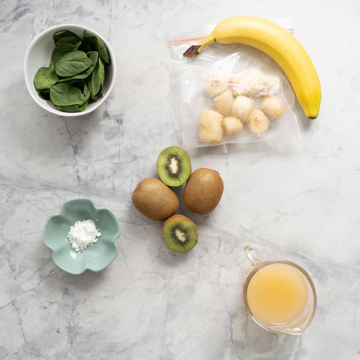 All the ingredients to make a kiwifruit popsicle laid out on the bench.